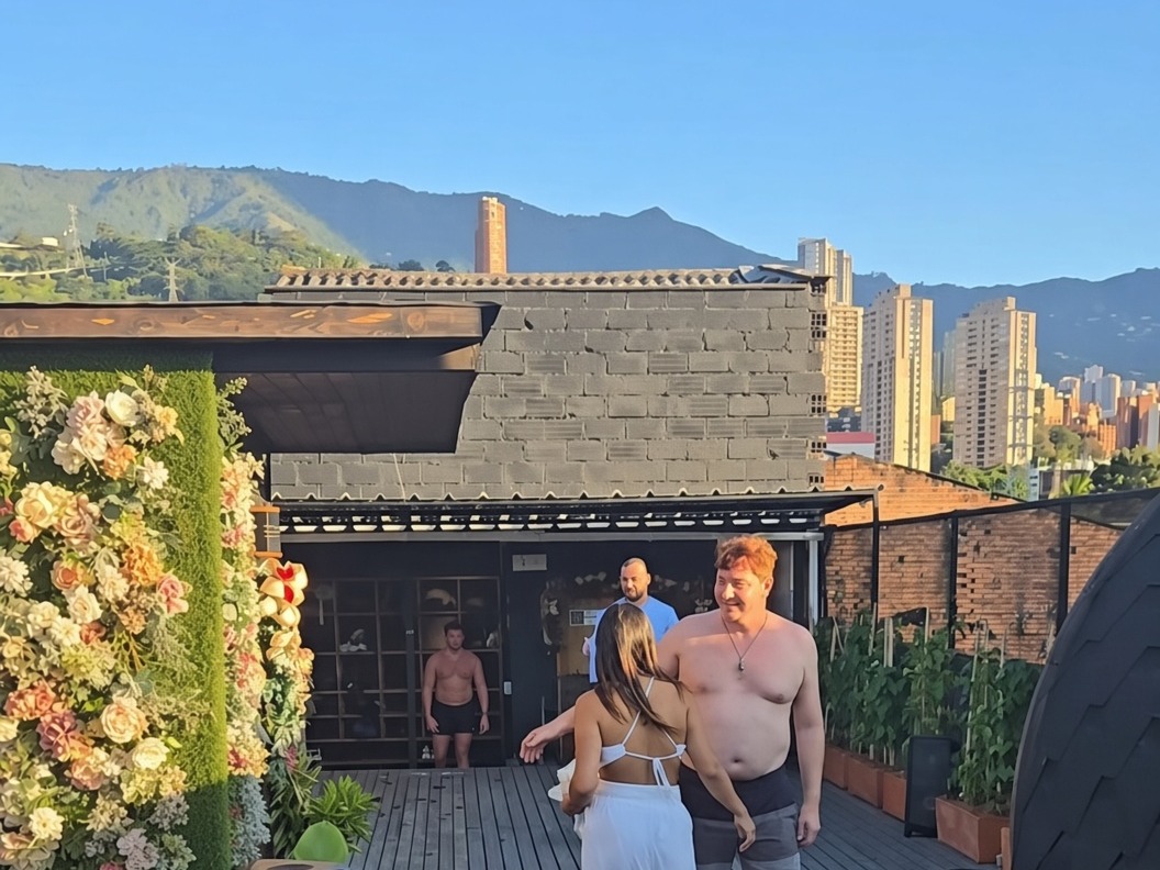 Floral wallpaper on the rooftop wall, women taking photos in front
